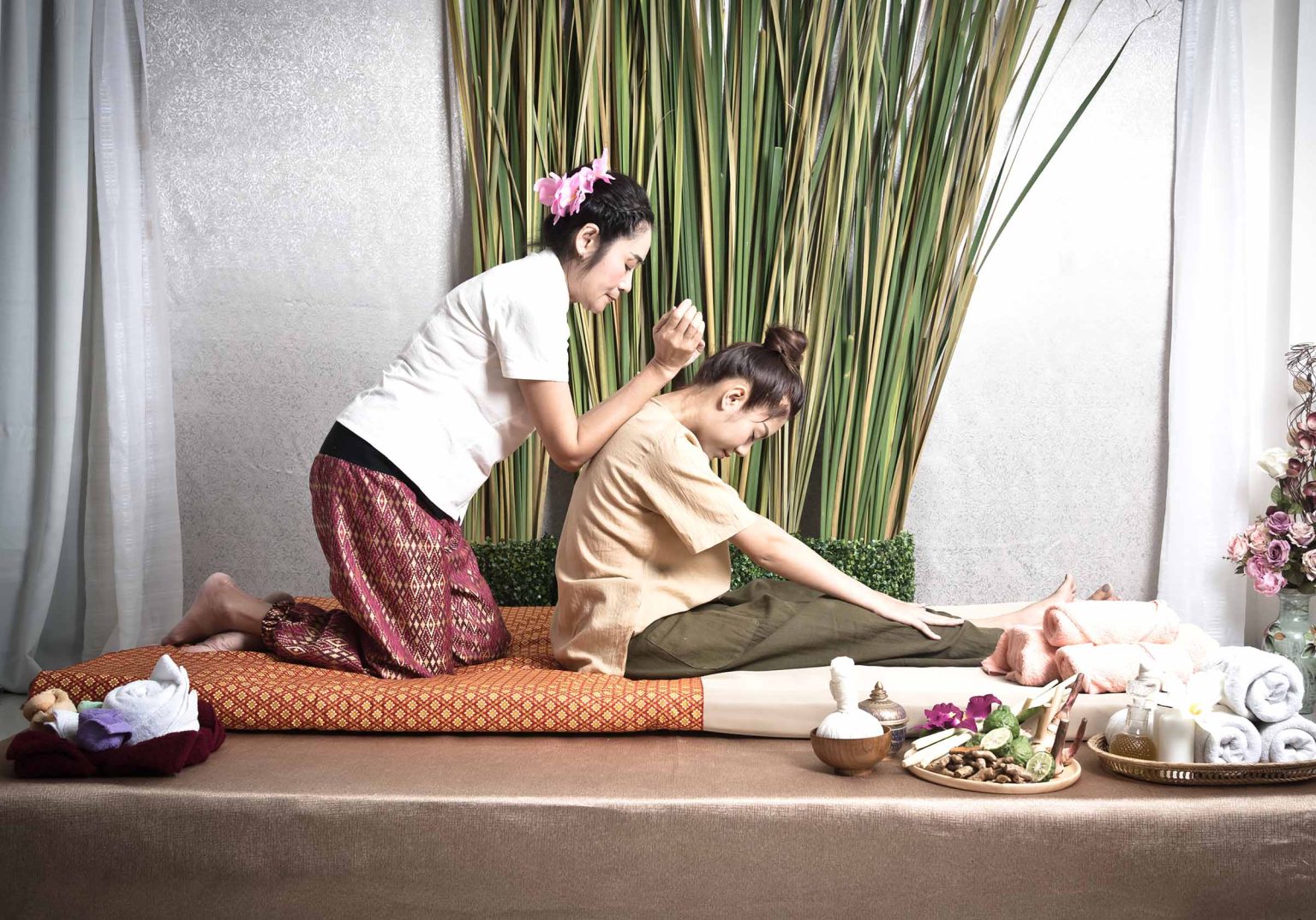 Thai Masseuse Doing Massage For Woman In Spa Salon. Asian Beauti